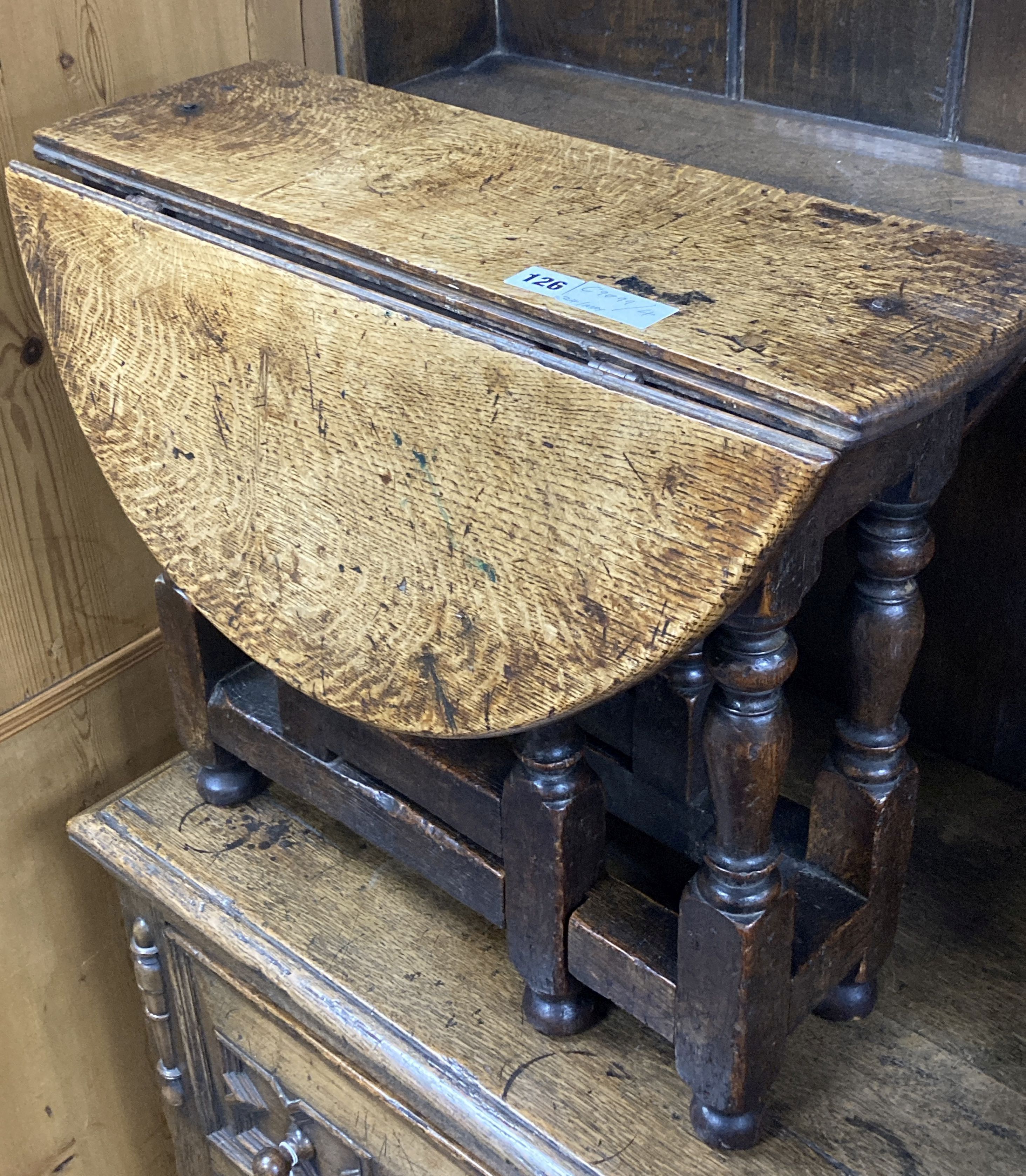 A 19th century miniature oak drop leaf gateleg table with turned supports, height 48cm, top 62 x 48cm